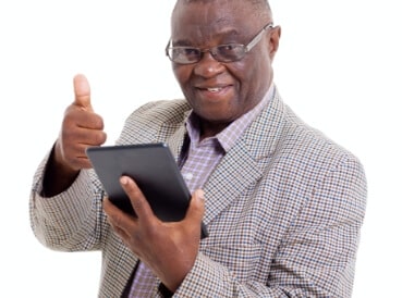 A senior man on his pad showing a thumbs up