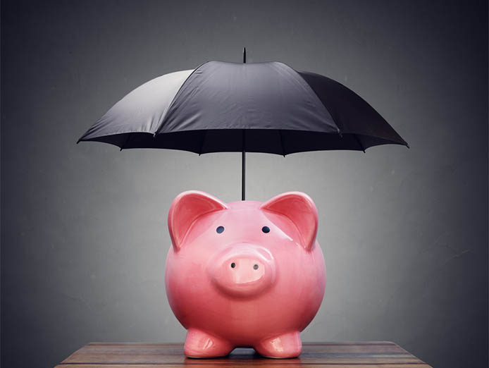 Piggy bank with a black open umbrella