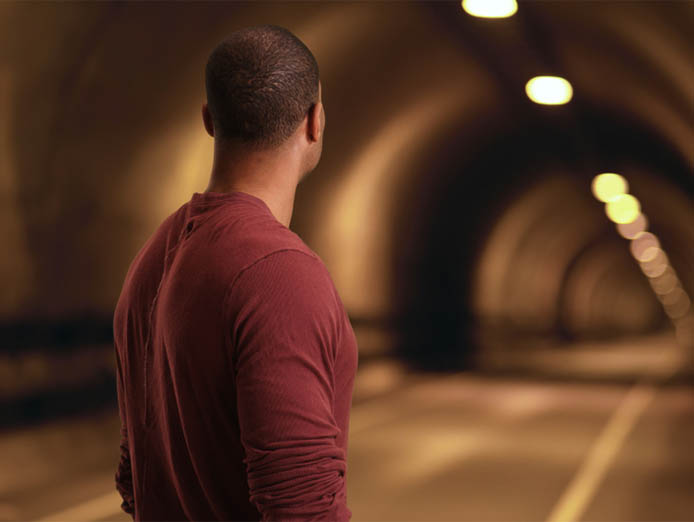 A man staring down a tunnel