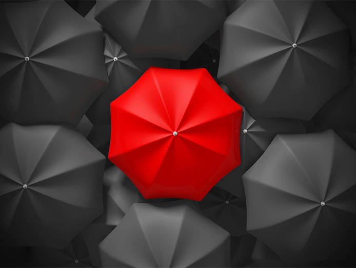 Black open umbrellas arranged in a circular motion with a red one at the middle