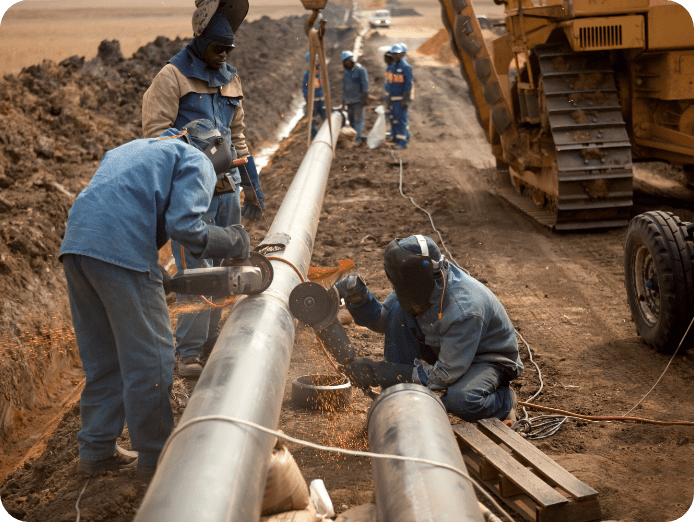 Workers constructing underground oil pipes