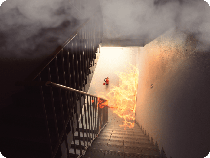 Fire in the stairs with fire extinguisher on the wall